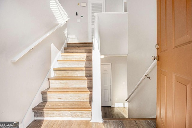 stairs with hardwood / wood-style floors