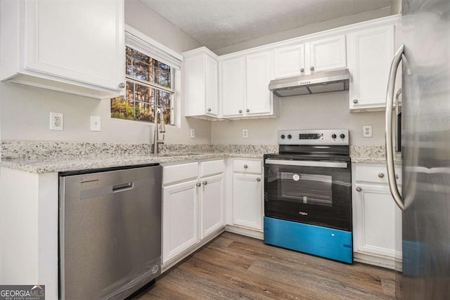 kitchen with appliances with stainless steel finishes, sink, and white cabinets