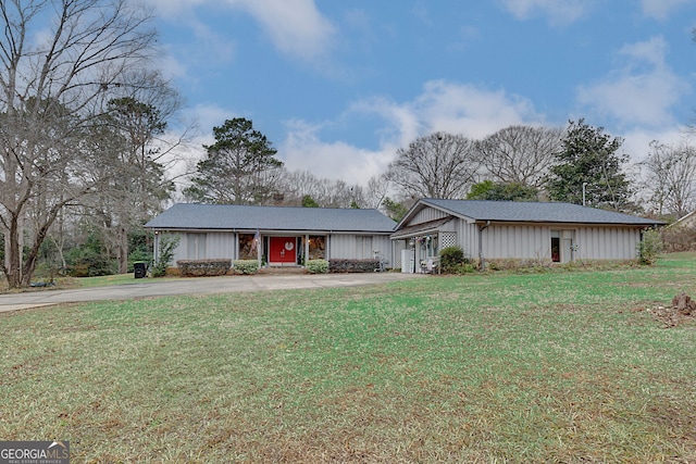 ranch-style home featuring a garage and a front yard