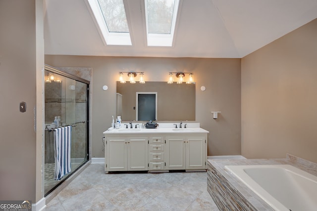 bathroom featuring vanity, lofted ceiling with skylight, and separate shower and tub