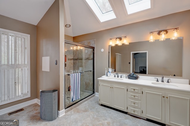 bathroom with plenty of natural light, vaulted ceiling with skylight, an enclosed shower, and vanity