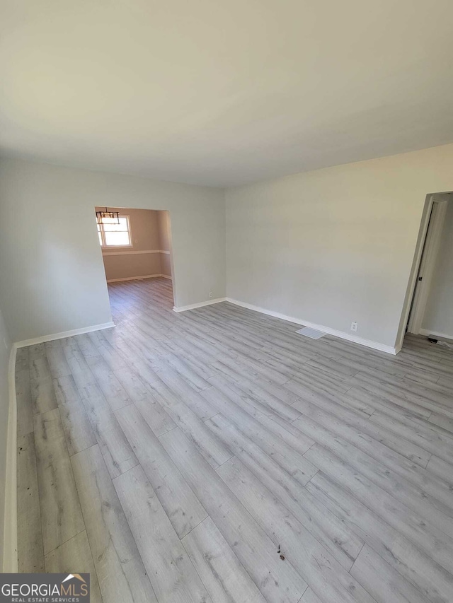 spare room with light hardwood / wood-style floors