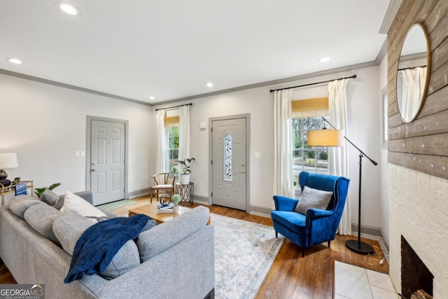 living room featuring light hardwood / wood-style flooring and ornamental molding