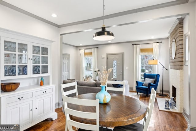 dining room with dark wood-type flooring and crown molding