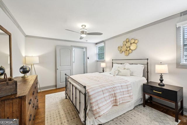 bedroom with crown molding, light hardwood / wood-style flooring, and ceiling fan