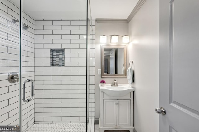 bathroom with crown molding, vanity, and a shower with shower door