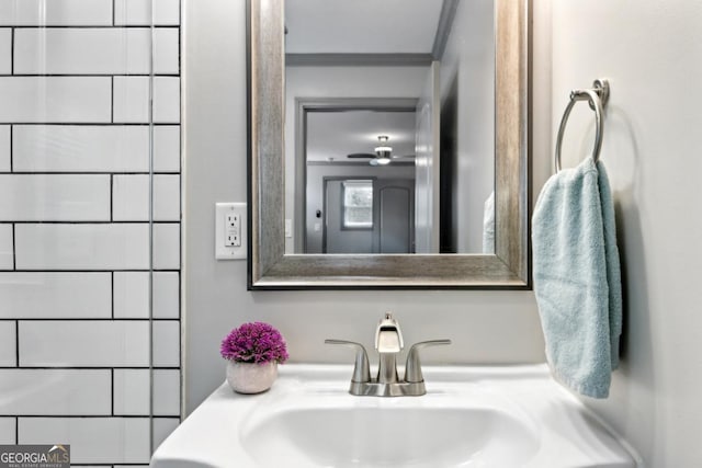 bathroom with vanity and ornamental molding