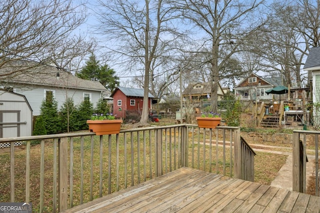 wooden deck with a yard and a shed