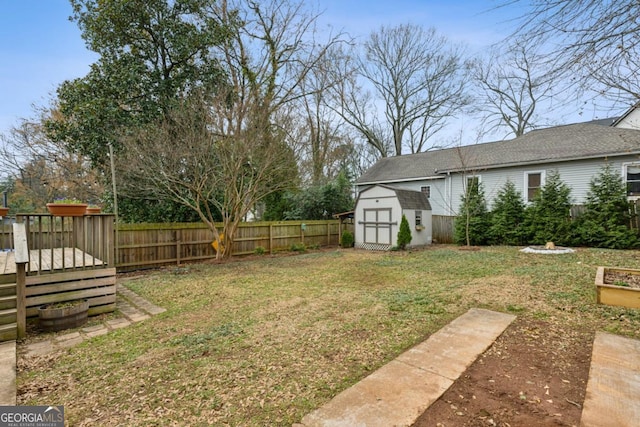 view of yard featuring a deck and a shed