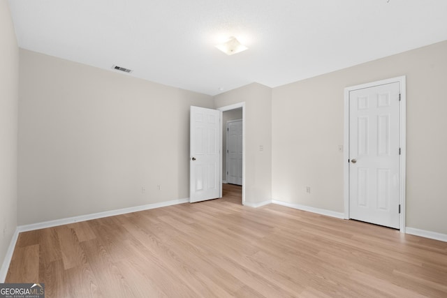 spare room featuring light hardwood / wood-style flooring