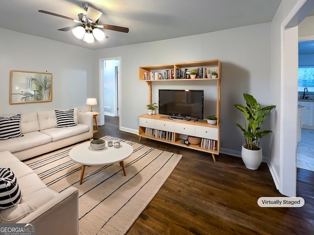 living room featuring dark hardwood / wood-style floors and ceiling fan