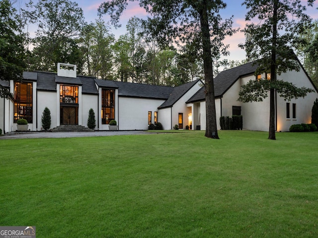 view of front of property featuring a yard and stucco siding