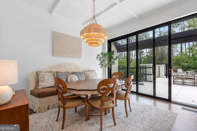 dining room featuring coffered ceiling, hardwood / wood-style flooring, and beamed ceiling