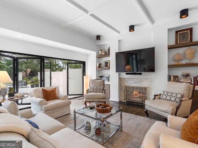 living area with recessed lighting, built in features, wood finished floors, a fireplace, and beam ceiling