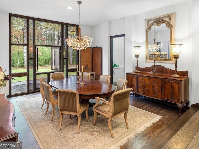 dining area with an inviting chandelier, expansive windows, wood finished floors, and recessed lighting
