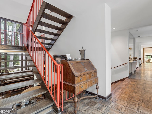 staircase featuring baseboards