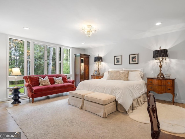 bedroom with wood finished floors and recessed lighting
