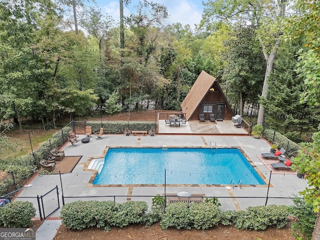 view of pool with a patio area, a fenced in pool, and fence