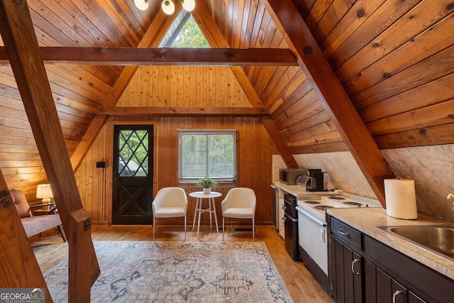 interior space featuring wooden ceiling, light wood finished floors, and vaulted ceiling with beams