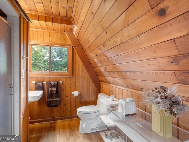 bathroom featuring toilet, wood-type flooring, wood walls, wooden ceiling, and vaulted ceiling