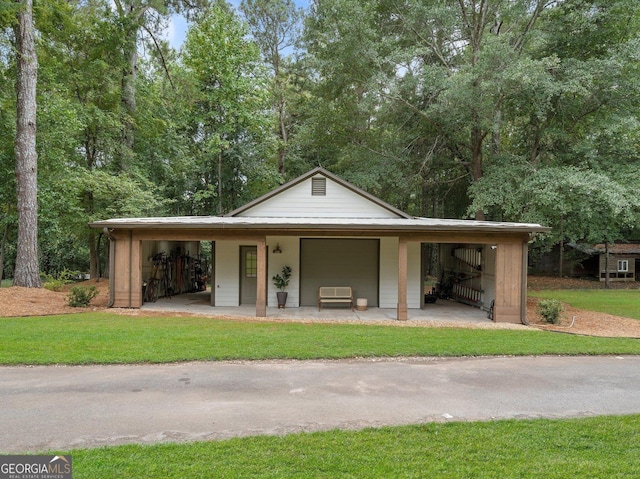 exterior space featuring a garage, a lawn, and a porch