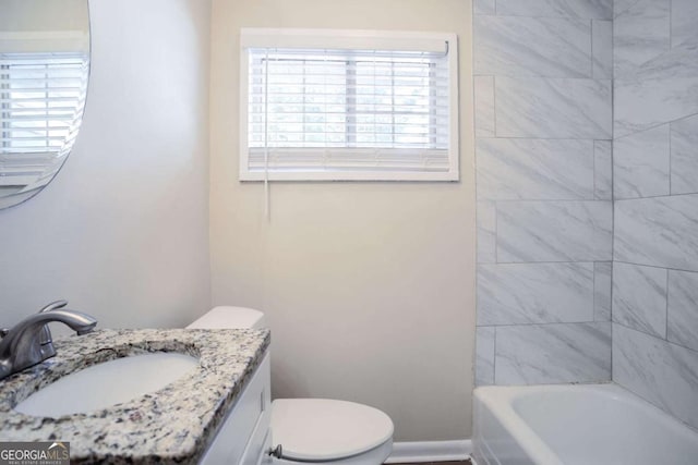 full bathroom featuring tiled shower / bath combo, vanity, and toilet