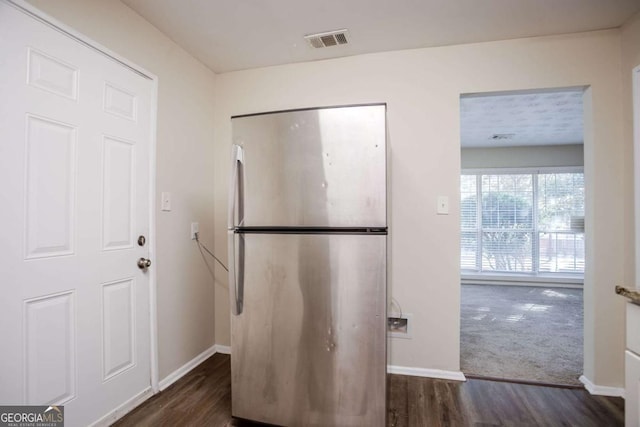 kitchen featuring dark wood-type flooring and stainless steel fridge