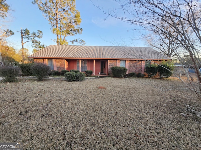 ranch-style home featuring metal roof