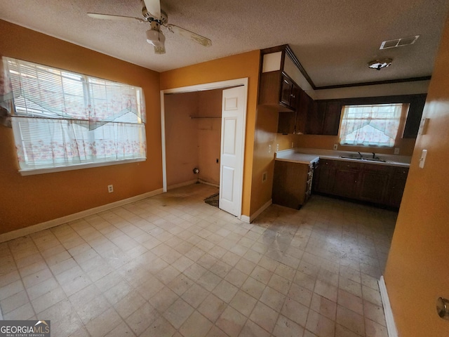 502 Navajo Ct, Albany, GA 31721 - kitchen with a sink, light floors, a ceiling fan, and a textured ceiling