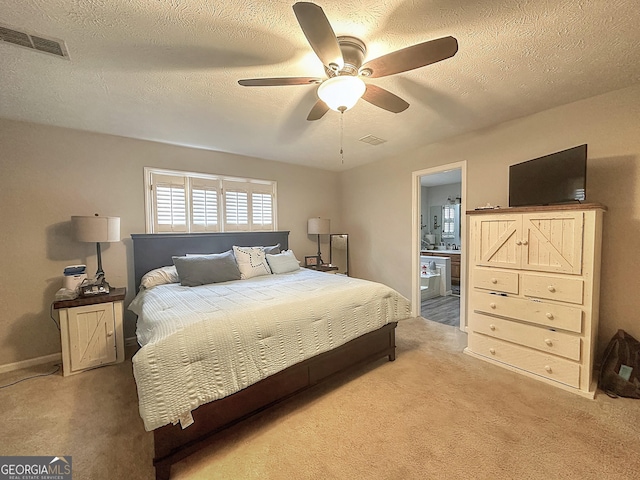 bedroom with connected bathroom, ceiling fan, a textured ceiling, and carpet