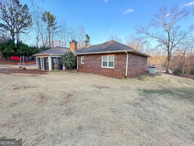 rear view of house with a yard