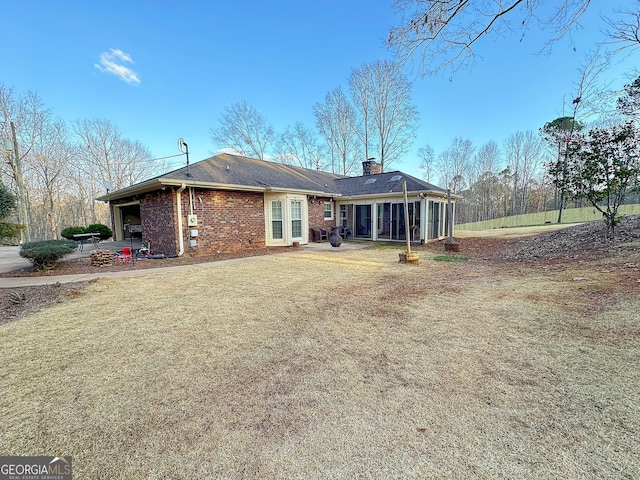 back of property featuring a yard