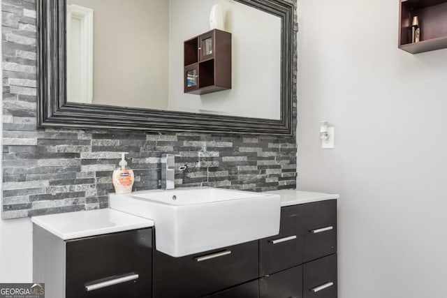 details featuring vanity and backsplash