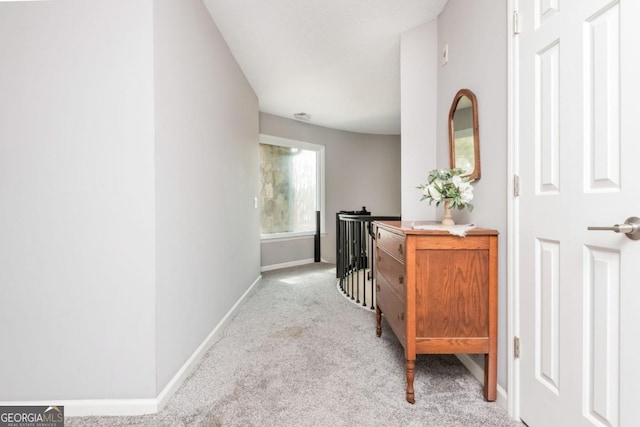 corridor featuring light colored carpet