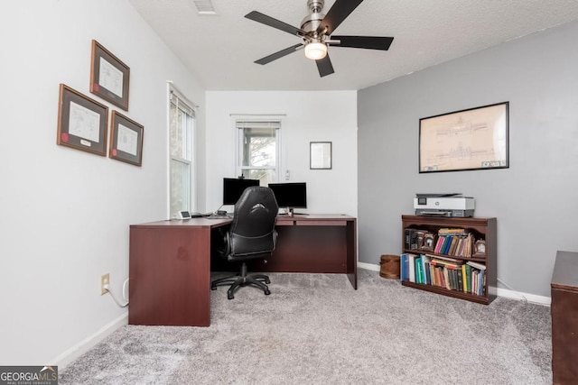 office area featuring ceiling fan, light colored carpet, and a textured ceiling