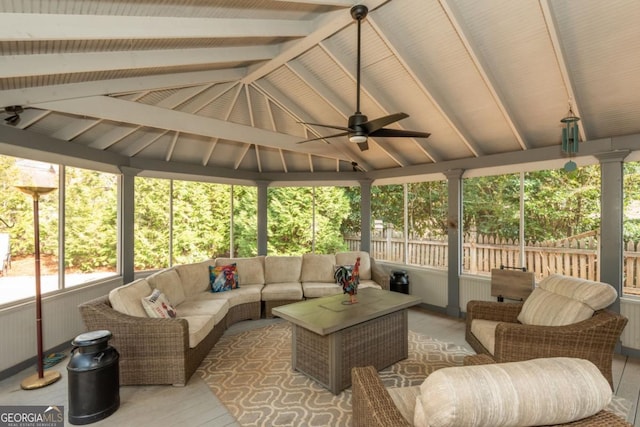 sunroom with lofted ceiling with beams and ceiling fan