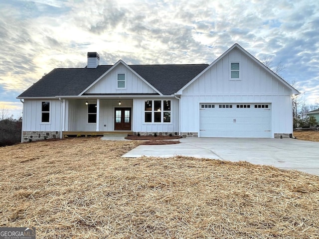 modern farmhouse style home featuring french doors and a garage