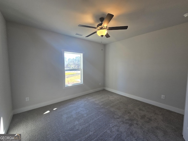 carpeted spare room with ceiling fan