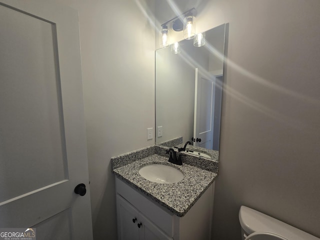 bathroom featuring vanity and toilet