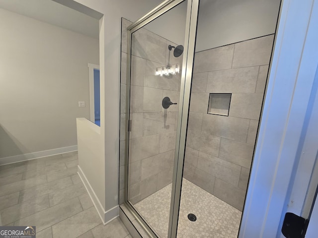 bathroom with an enclosed shower and tile patterned flooring