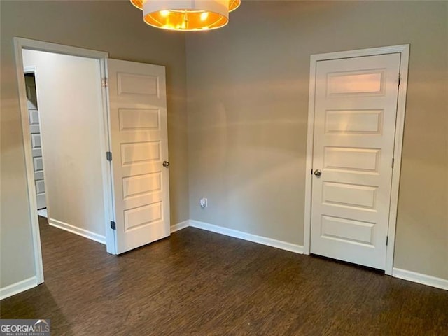 empty room with dark hardwood / wood-style floors