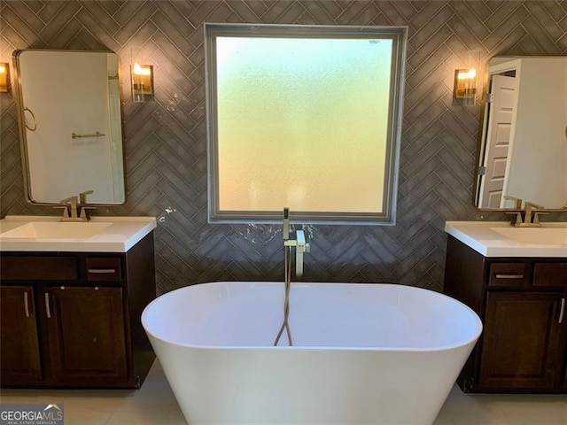 bathroom with vanity, a washtub, and tile walls