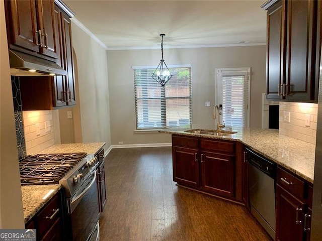 kitchen featuring sink, hanging light fixtures, ornamental molding, appliances with stainless steel finishes, and dark hardwood / wood-style floors