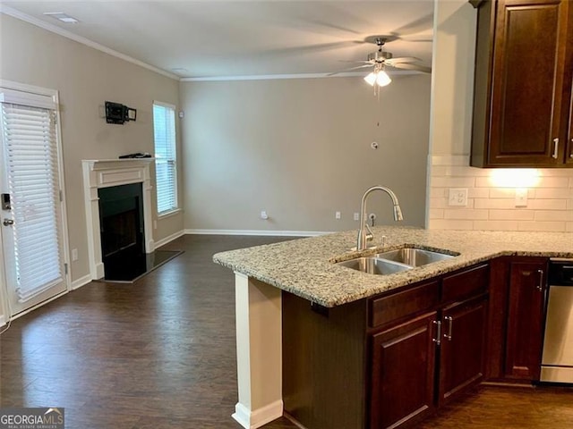 kitchen featuring sink, light stone counters, stainless steel dishwasher, dark hardwood / wood-style flooring, and kitchen peninsula