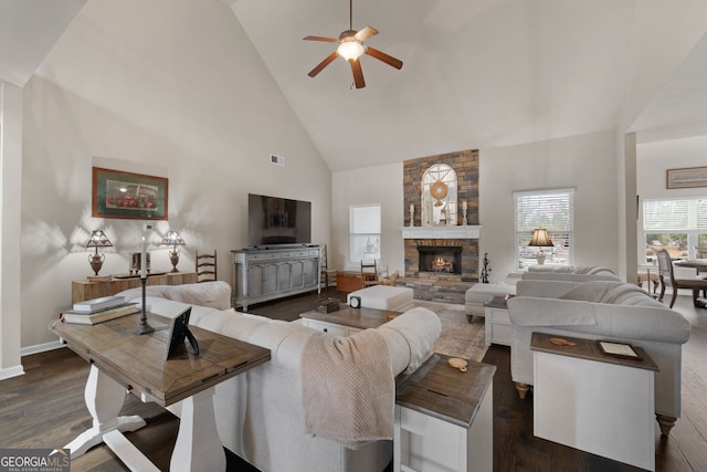 living room with a fireplace, high vaulted ceiling, dark hardwood / wood-style floors, and ceiling fan