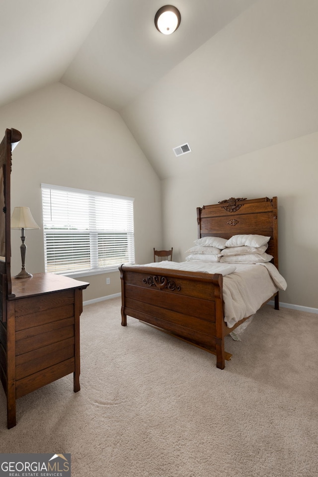 carpeted bedroom featuring lofted ceiling