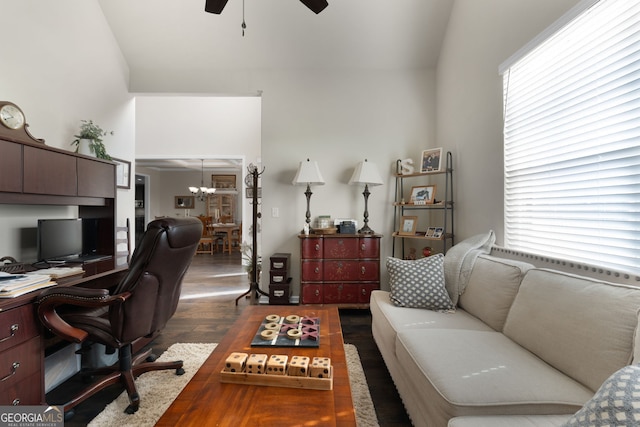 home office featuring dark hardwood / wood-style floors and ceiling fan with notable chandelier