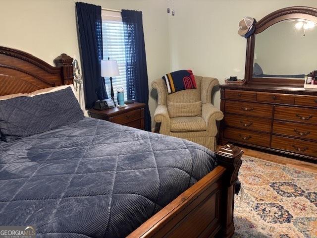 bedroom with hardwood / wood-style flooring