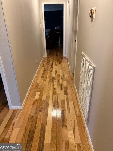 corridor with light hardwood / wood-style floors