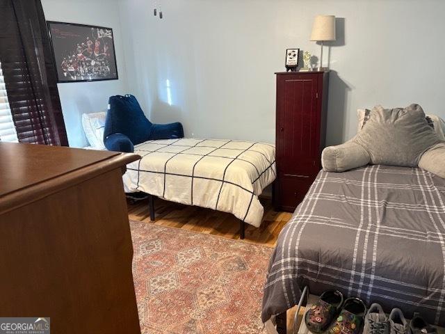 bedroom featuring wood-type flooring